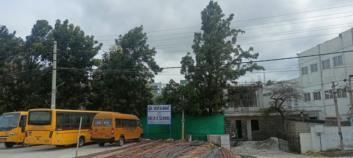 Sri R.V. school buses parked near the campus gate