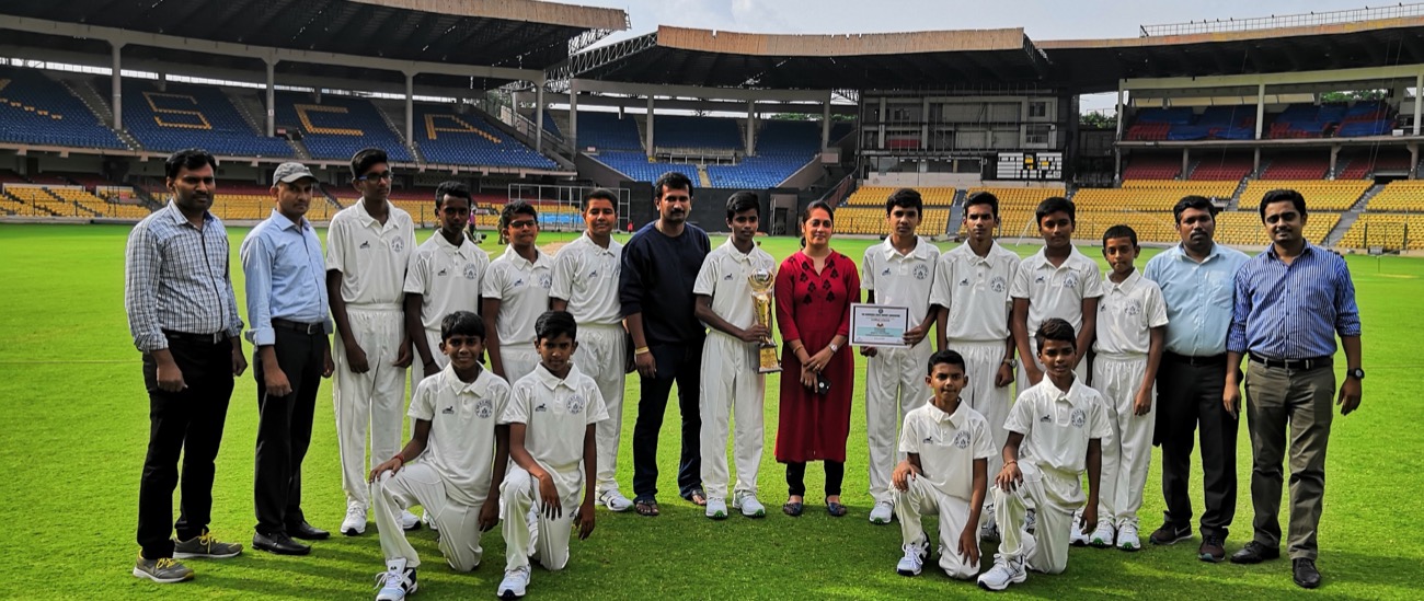 Sri R.V. cricket team with coaches at a stadium