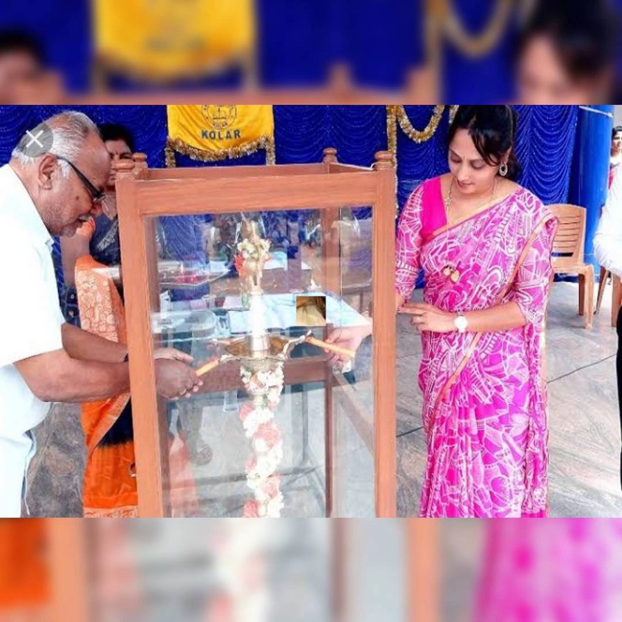 Guests lighting the ceremonial lamp at a college event